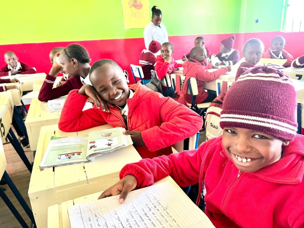 Boys writing at their desks in class