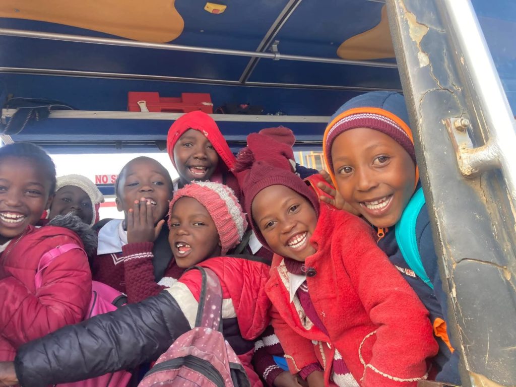 Smiling pupils on the school bus